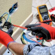 Electrician inspecting home wiring during annual electrical inspection in Seattle