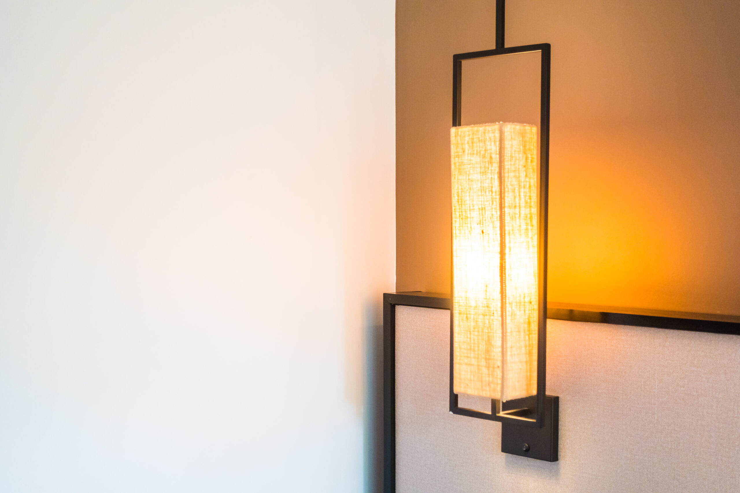 Wall-mounted light fixture flickering in a Seattle home, indicating possible electrical issue needing repair