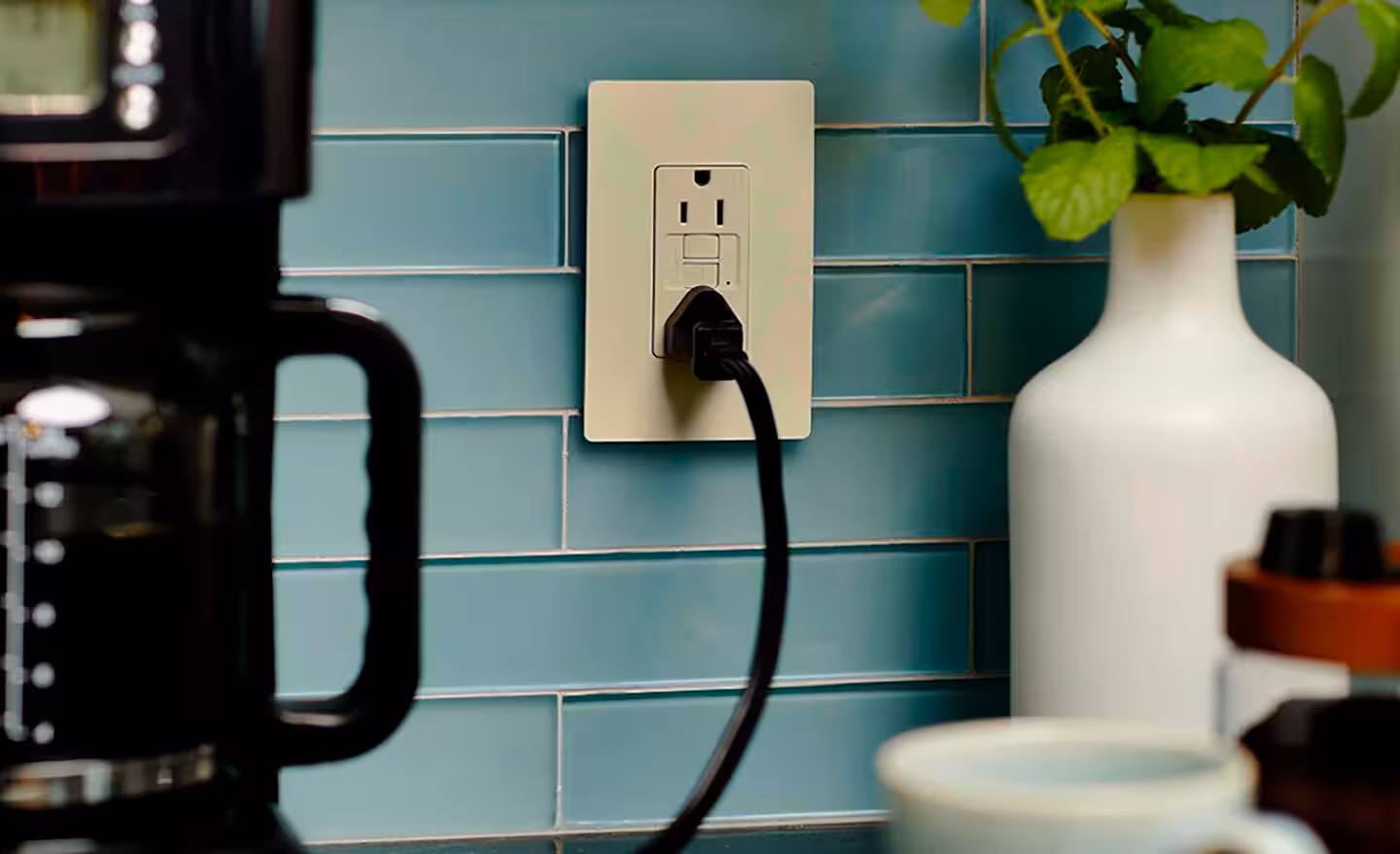 GFCI outlet with flush test and reset buttons installed on a wall, commonly used in bathrooms and kitchens when an outlet keeps tripping