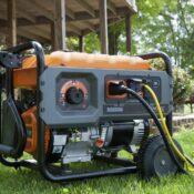 Portable generator running outdoors providing backup power for a home during an outage