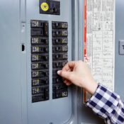 Residential electrician in Renton WA repairing and inspecting a home electrical breaker panel