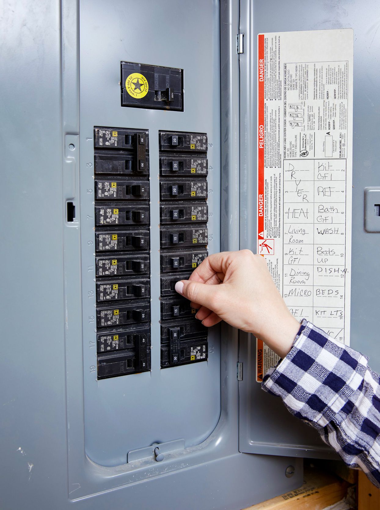 Residential electrician in Renton WA repairing and inspecting a home electrical breaker panel