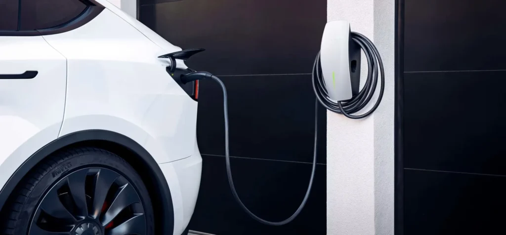 Tesla vehicle charging at home using a wall-mounted Tesla wall connector on a dedicated electrical circuit