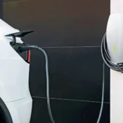 Tesla vehicle charging at home using a wall-mounted Tesla wall connector installed by a licensed electrician